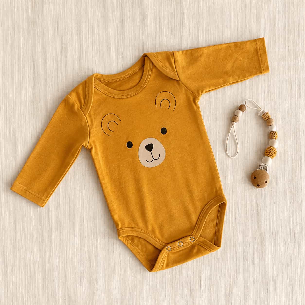 Soft baby clothing arranged on a light surface